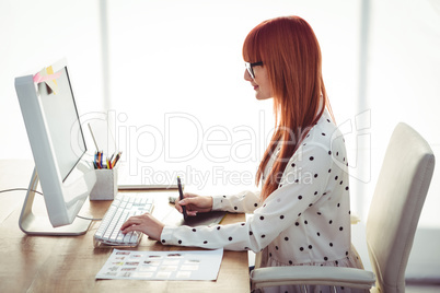 Attractive hipster woman using graphics tablet