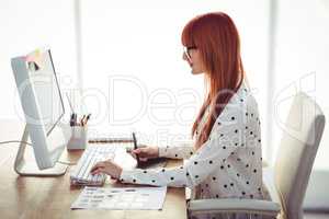 Attractive hipster woman using graphics tablet