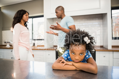 Parents arguing in front of daughter