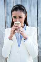 Smiling businesswoman with take-away coffee