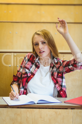 Unsure student raising the hand during class