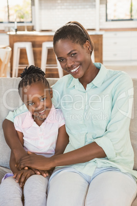 Loving mother with daughter on the couch