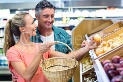 Happy couple holding potatoes