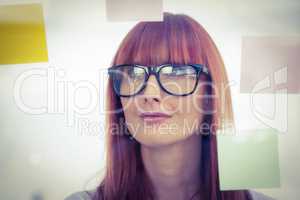 Attractive hipster woman looking at sticky notes