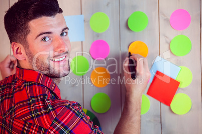 Creative worker using wall for brainstorm