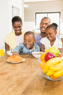 Casual happy family having breakfast