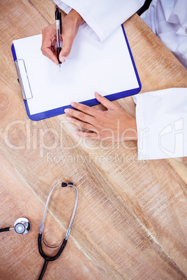 Doctor writing on clipboard Doctor writing on clipboard