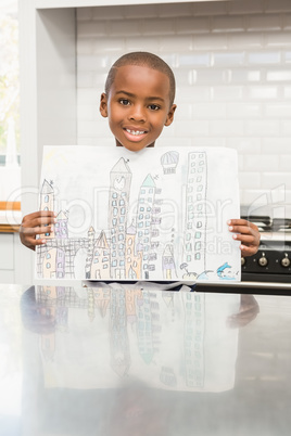 Smiling boy showing his drawing Smiling boy showing his drawing