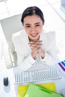 Businesswoman using her pc with documents