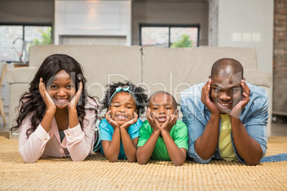 Happy family lying on the floor at home