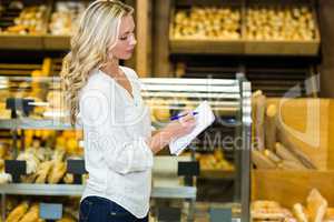 Blonde woman checking list