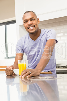 Casual happy man having breakfast