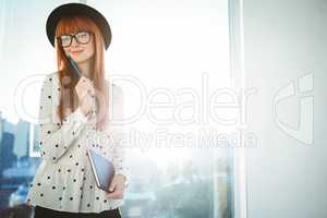 Smiling hipster woman writing notes
