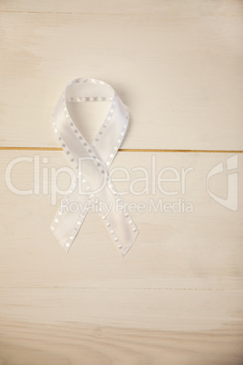 White ribbon on wooden desk