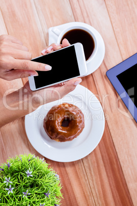 Overhead of feminine hands using smartphone