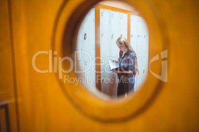 Standing student studying seen trough the window