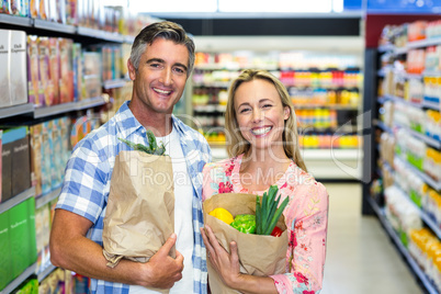 Smiling couple with grocery bags