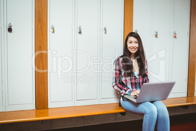 Smiling student sitting at the computer