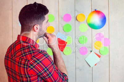 Creative worker using wall for brainstorm