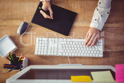 Cropped image of woman using graphics tablet