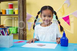 Smiling girl with her arts and crafts