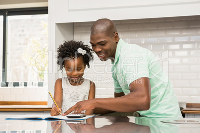 Father helping his daughter with homework