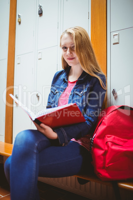 Focused student sitting and studying on notebook