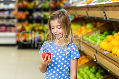 Cute kid looking at an apple