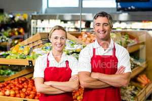 Portrait of smiling couple wearing apron