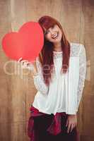 Smiling hipster woman with a big red heart