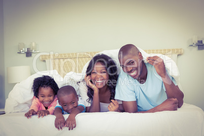 Happy family lying on bed