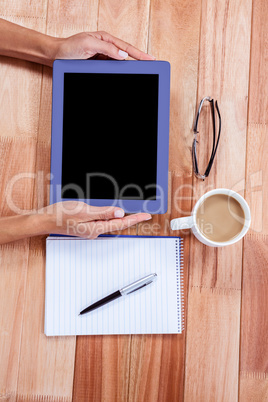 Overhead of feminine hands using tablet