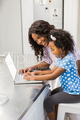 Daughter using laptop with mother