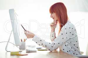 Smiling hipster woman pointing screen with pen