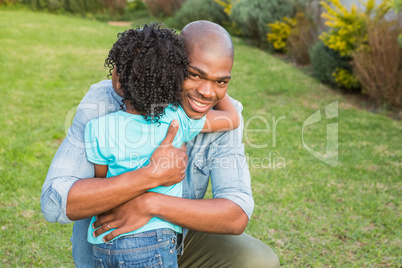 Smiling father hugging his daughter