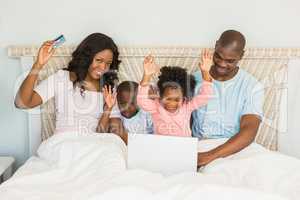 Happy family shopping online with laptop