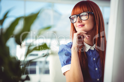 Attractive smiling hipster woman thinking