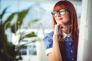 Attractive smiling hipster woman thinking