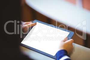 Student in lecture hall using tablet