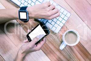 Feminine hands using smartphone and smart watch