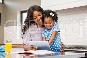 Mother and daughter using tablet