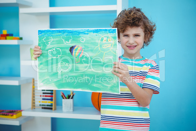 Smiling boy holding a picture