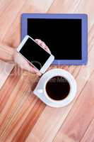 Businesswoman using her smartphone on desk