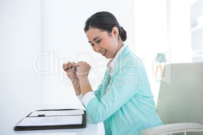 Smiling businesswoman looking at her diary