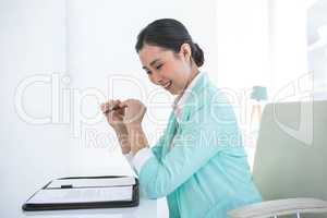 Smiling businesswoman looking at her diary