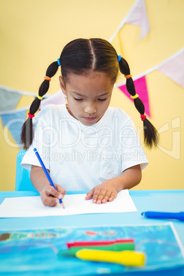 Focused girl drawing on paper