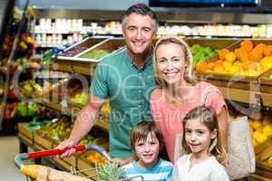 Young Family posing together with trolley