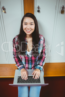 Smiling student sitting at the computer