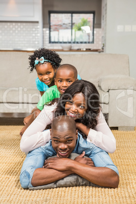 Happy family lying on the floor at home