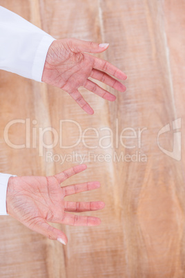 Close up view of hands on wood desk